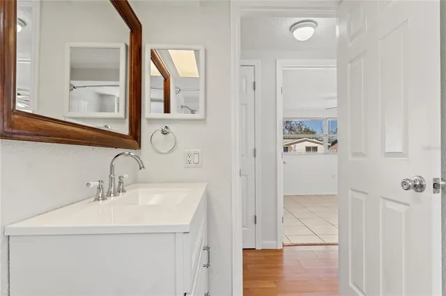 a bathroom with a sink a mirror and shower