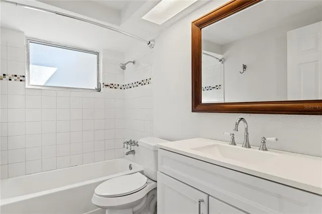 a bathroom with a sink a toilet and a bathtub
