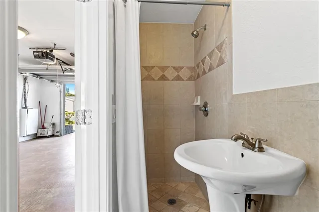 a bathroom with a sink a mirror and shower