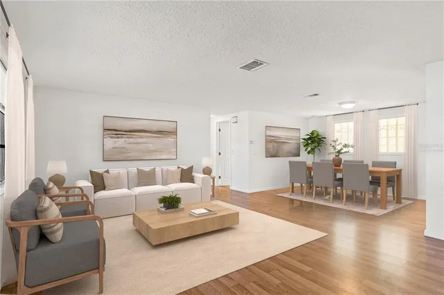 a living room with furniture and wooden floor