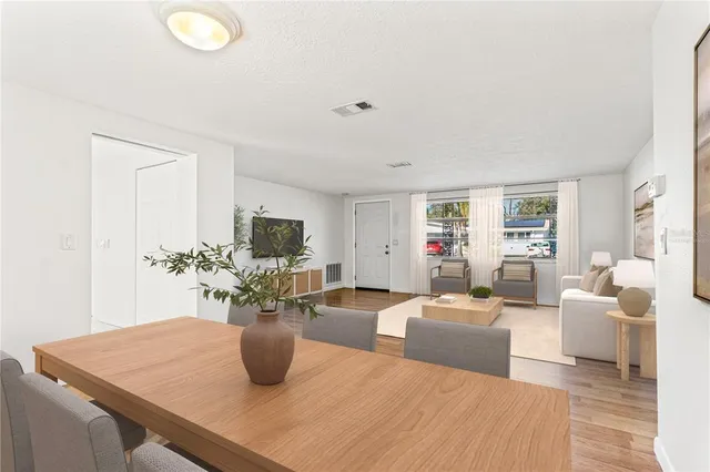a living room with furniture potted plant and a large mirror