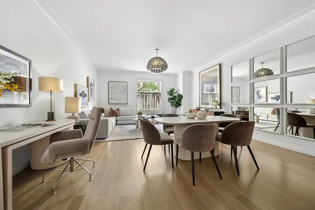 a view of a dining room with furniture window and wooden floor