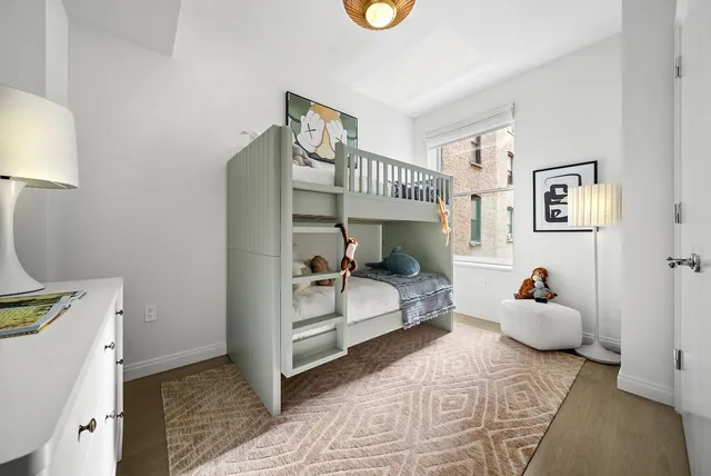 a bedroom with furniture and a window