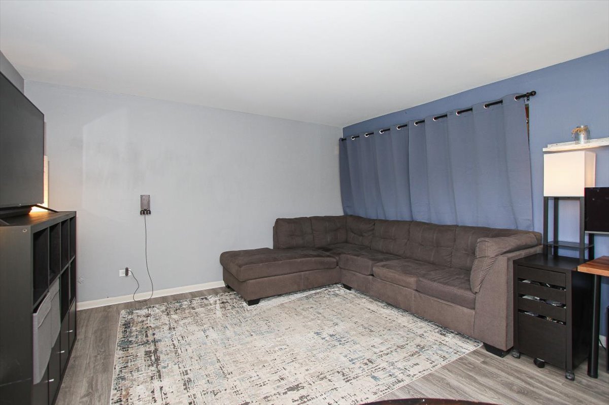 2300 Old Tavern Road, Unit 203 Lisle, IL 60532 - Photo 4 of 26 a living room with furniture and a flat screen tv