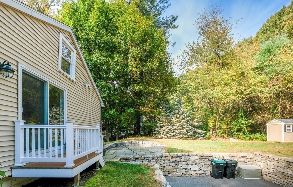 223 Stonebridge Road Wayland, MA 01778 - Photo 6 of 6 a view of a patio with table and chairs and potted plants