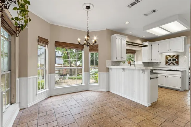 a kitchen with a sink stove top oven and cabinets