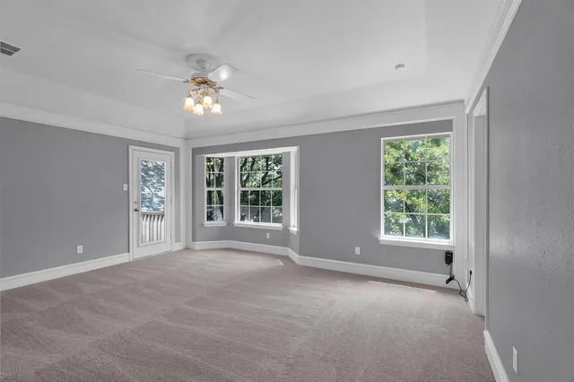 a view of a livingroom with a ceiling fan and window