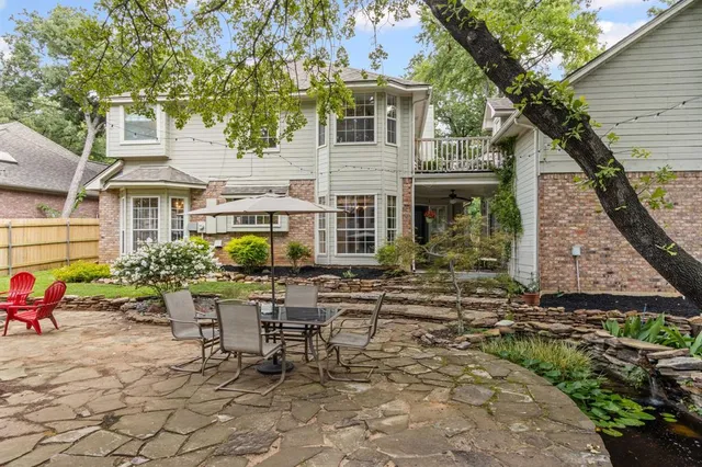 a view of a dining room with furniture and a chandelier