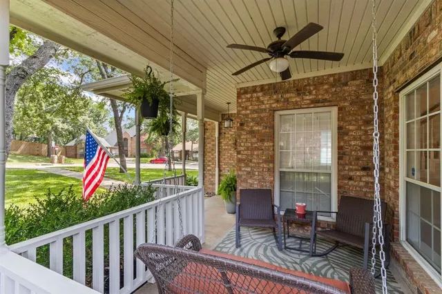 a view of a porch with furniture and a yard
