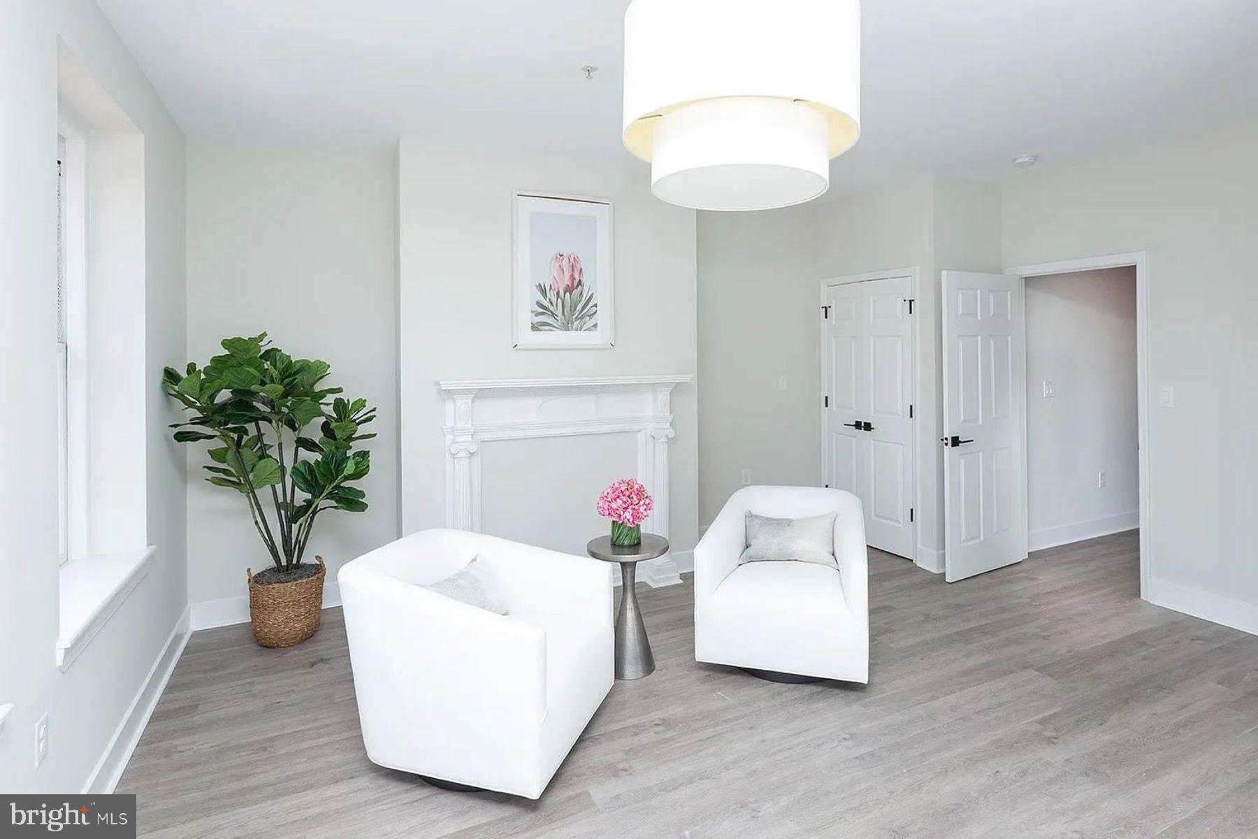 1122 North Calvert Street, Unit 1 Baltimore, MD 21202 - Photo 1 of 8 a living room with furniture and flowers
