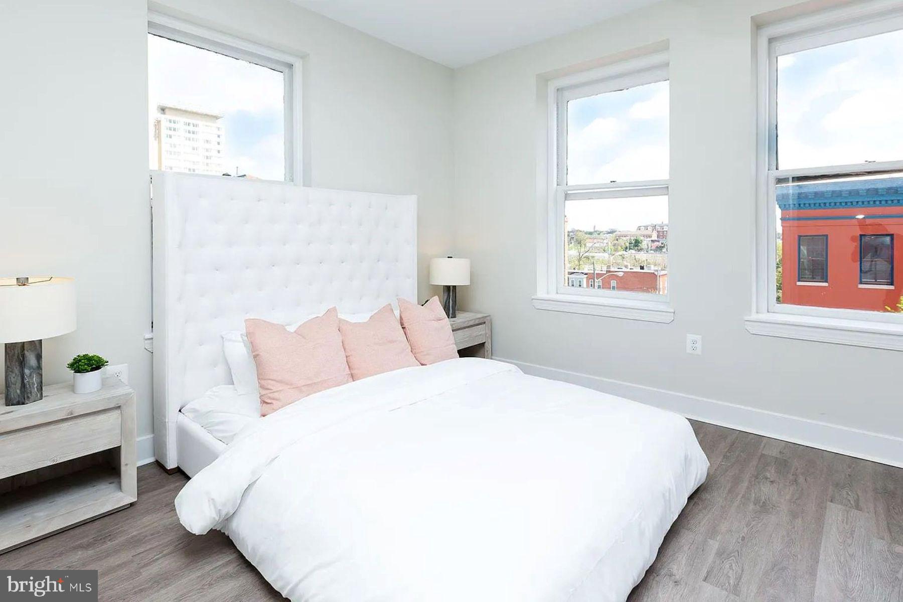 1122 North Calvert Street, Unit 1 Baltimore, MD 21202 - Photo 6 of 8 a bedroom with a bed and a window