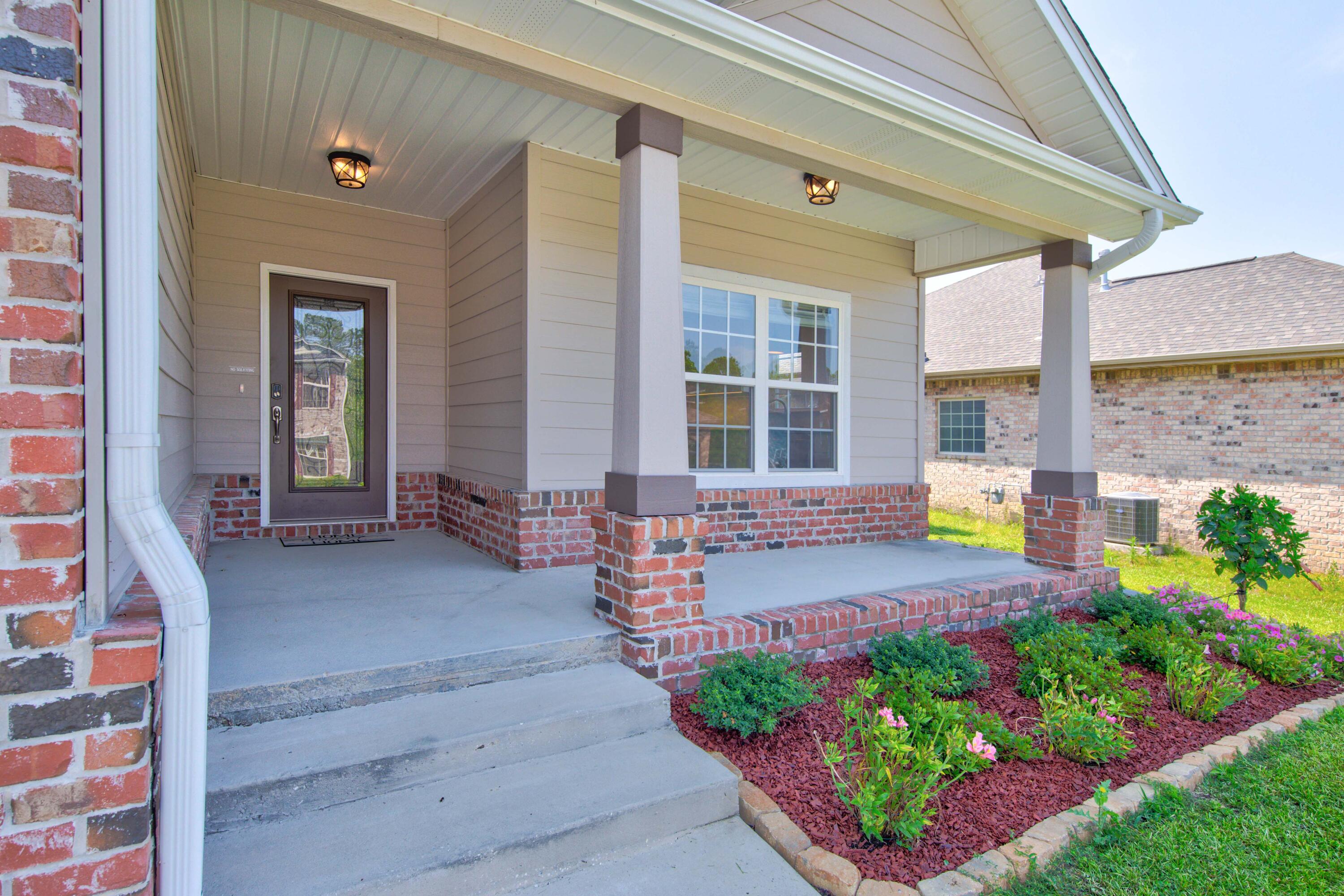 4557 Hermosa Road Crestview, FL 32539 - Photo 1 of 29 a front view of a house with outdoor seating
