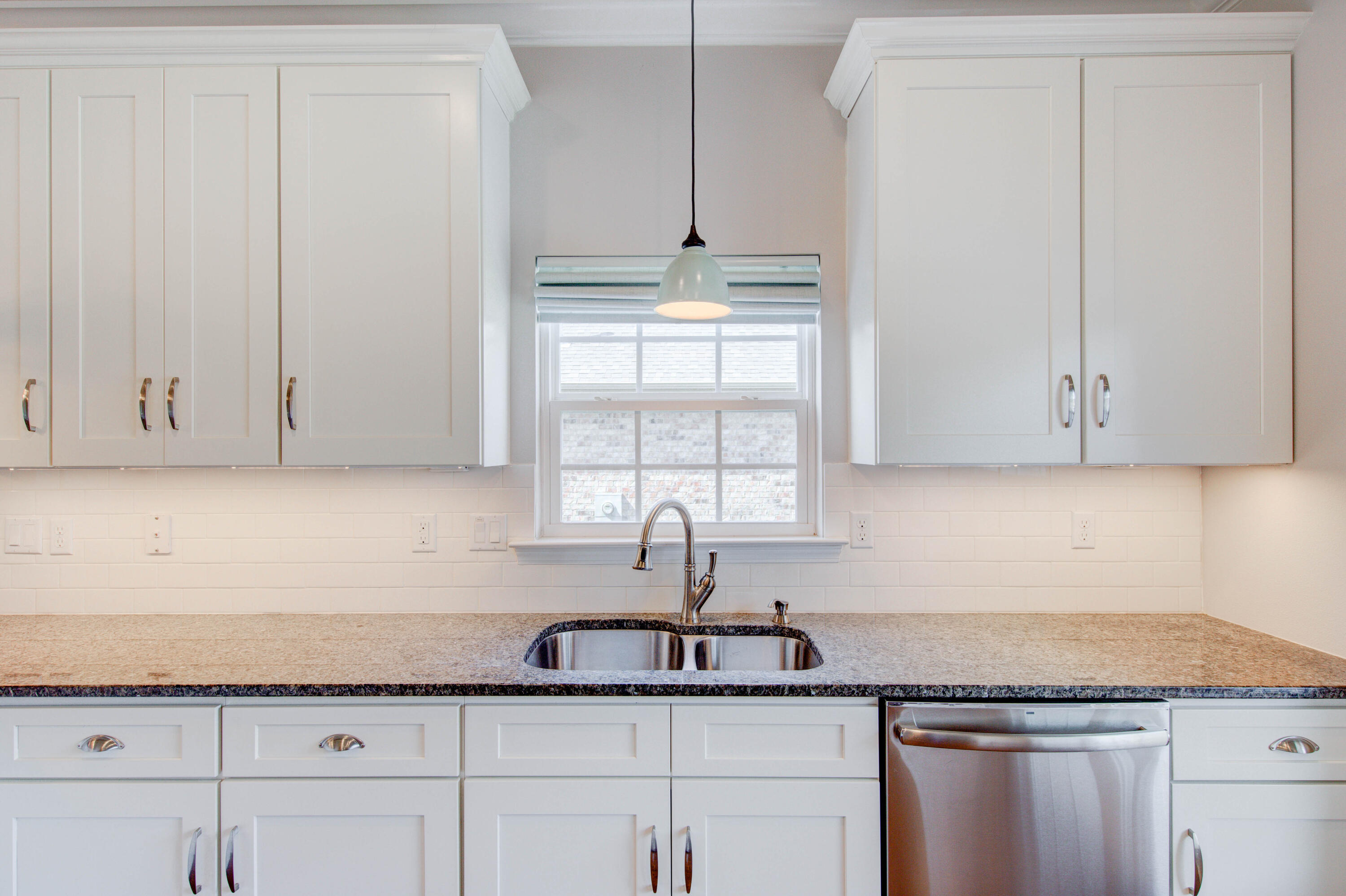 4557 Hermosa Road Crestview, FL 32539 - Photo 13 of 29 a kitchen with granite countertop white cabinets and white appliances