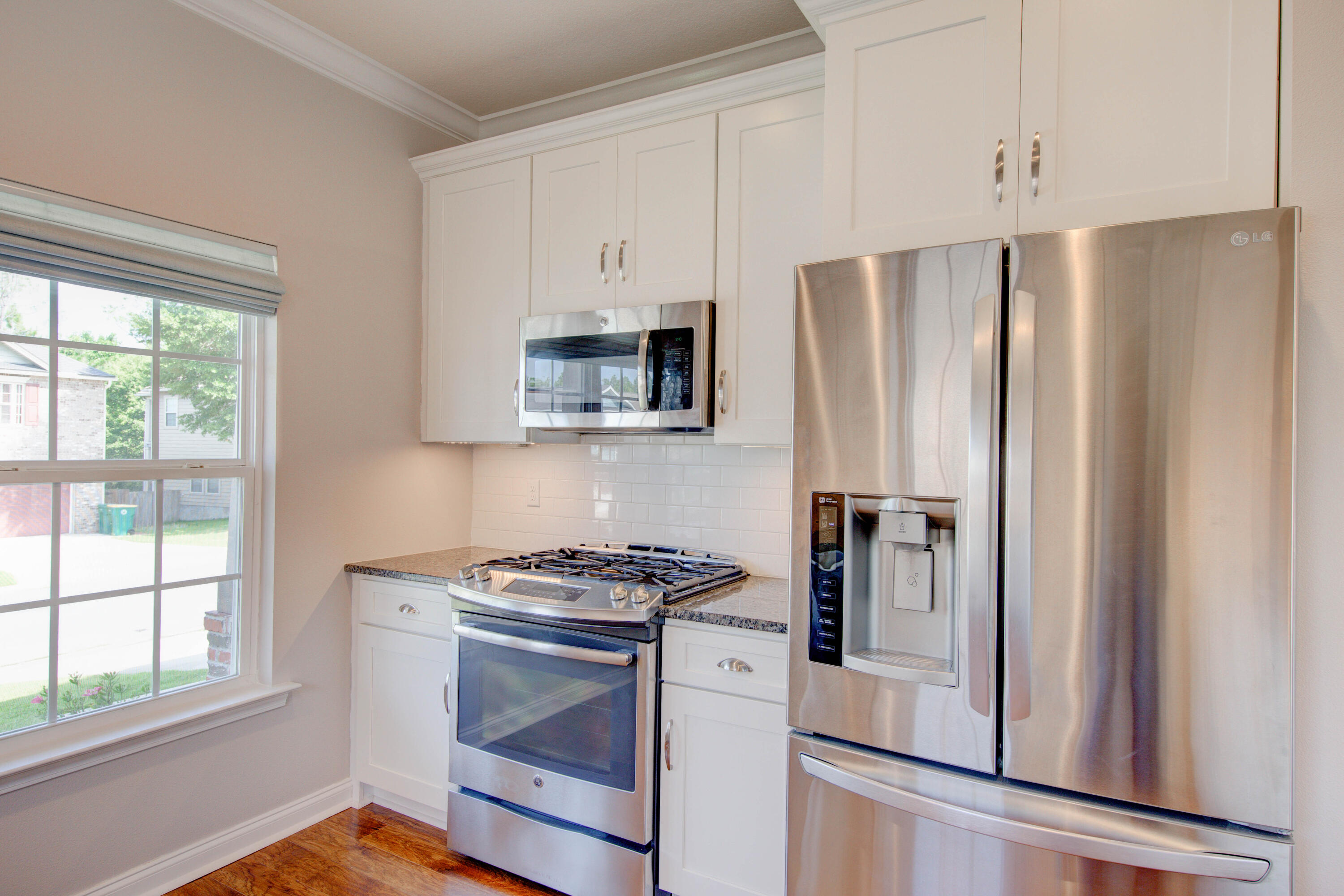 4557 Hermosa Road Crestview, FL 32539 - Photo 14 of 29 a kitchen with stainless steel appliances a refrigerator stove and sink