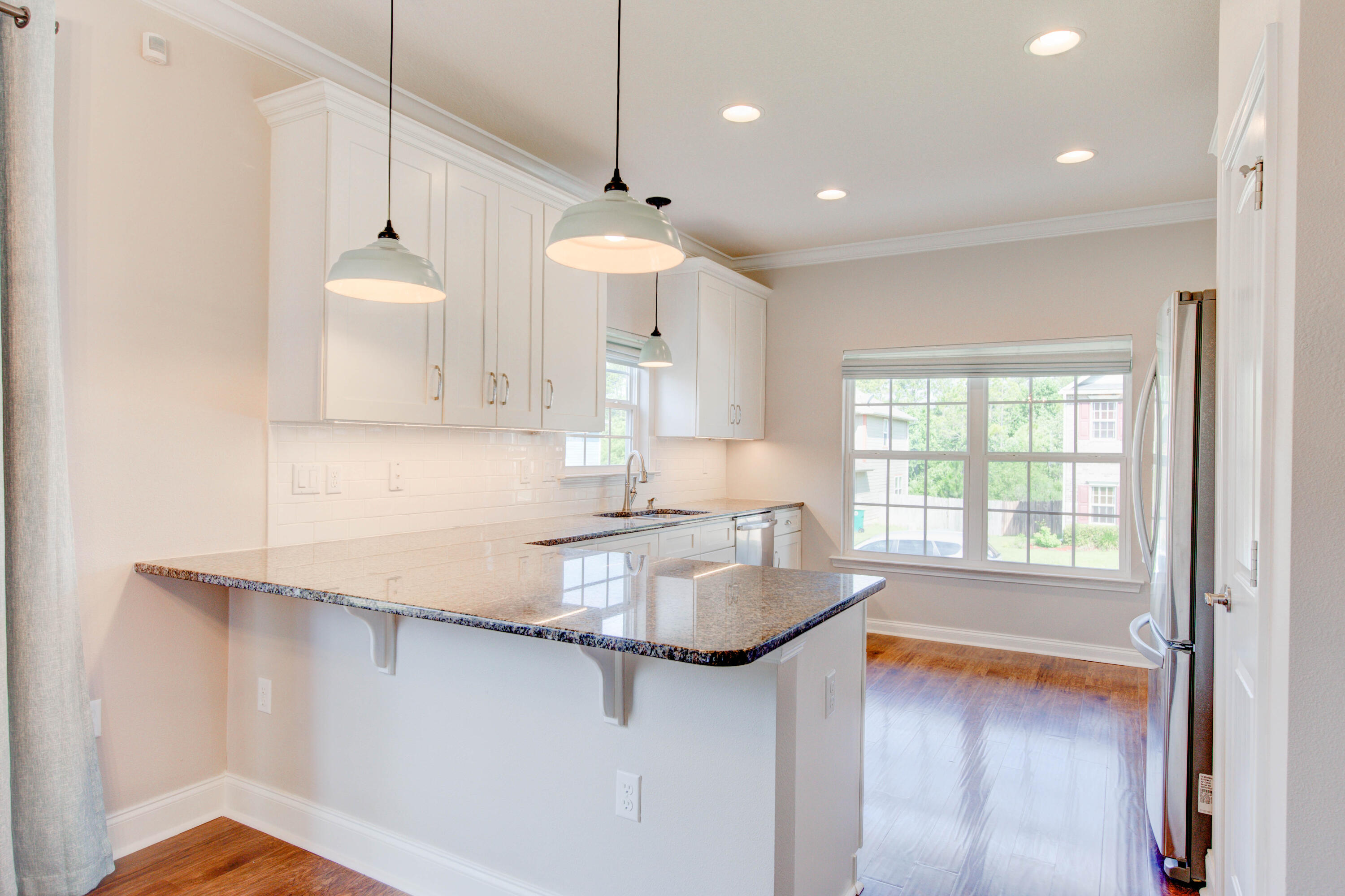 4557 Hermosa Road Crestview, FL 32539 - Photo 15 of 29 a kitchen with stainless steel appliances granite countertop a sink a stove and a refrigerator