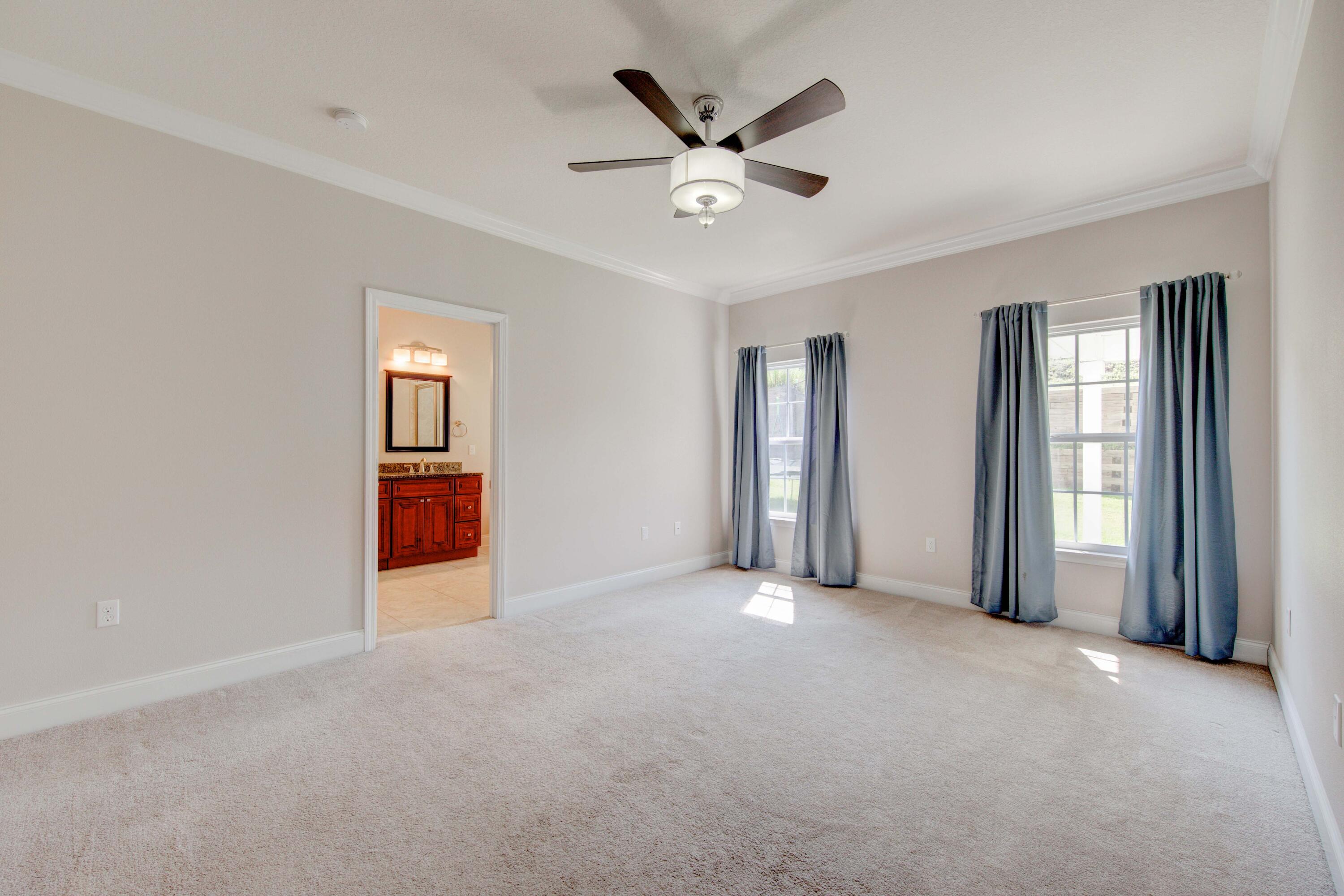 4557 Hermosa Road Crestview, FL 32539 - Photo 17 of 29 an empty room with windows and fan