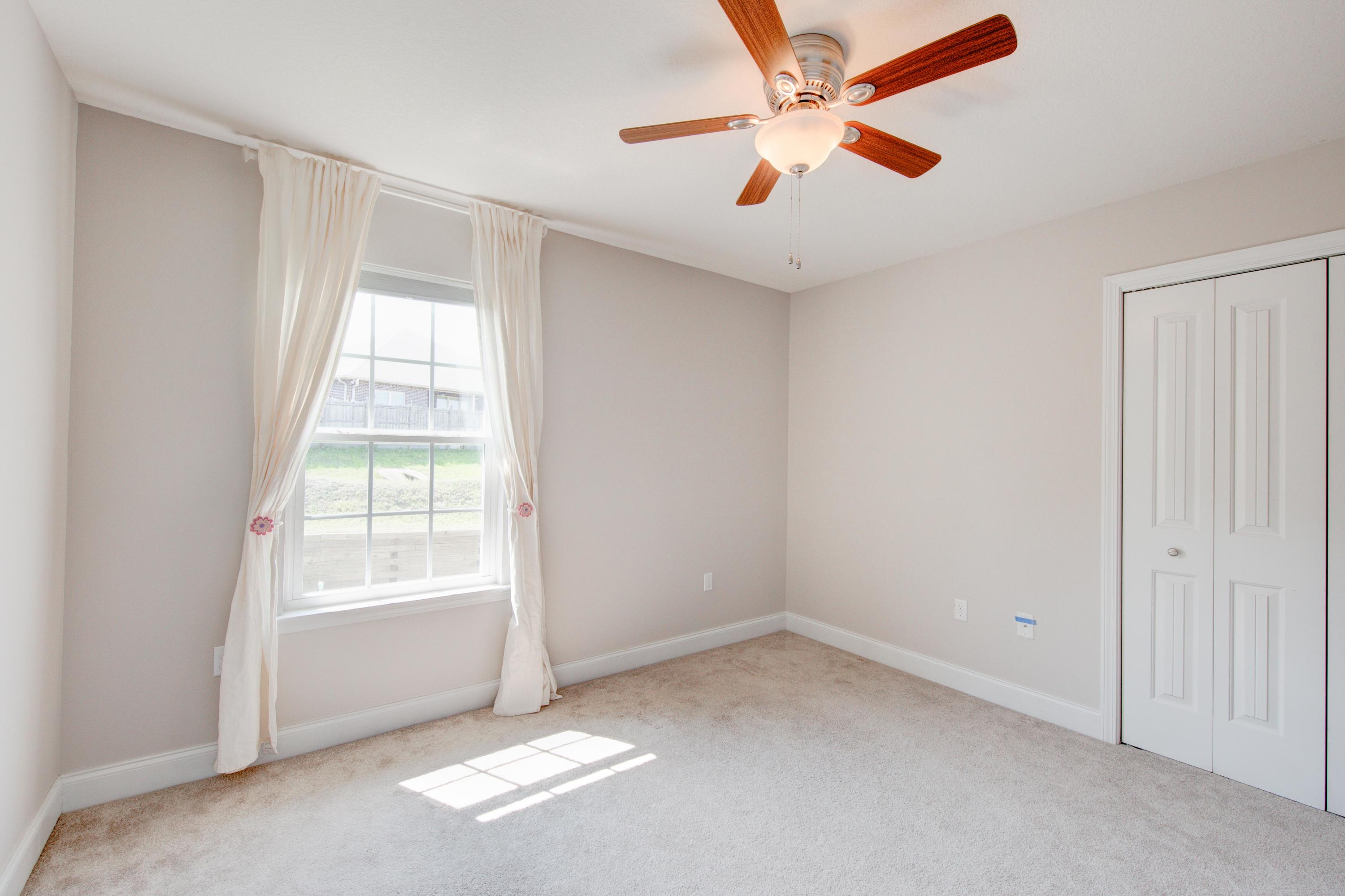 4557 Hermosa Road Crestview, FL 32539 - Photo 24 of 29 an empty room with windows and fan