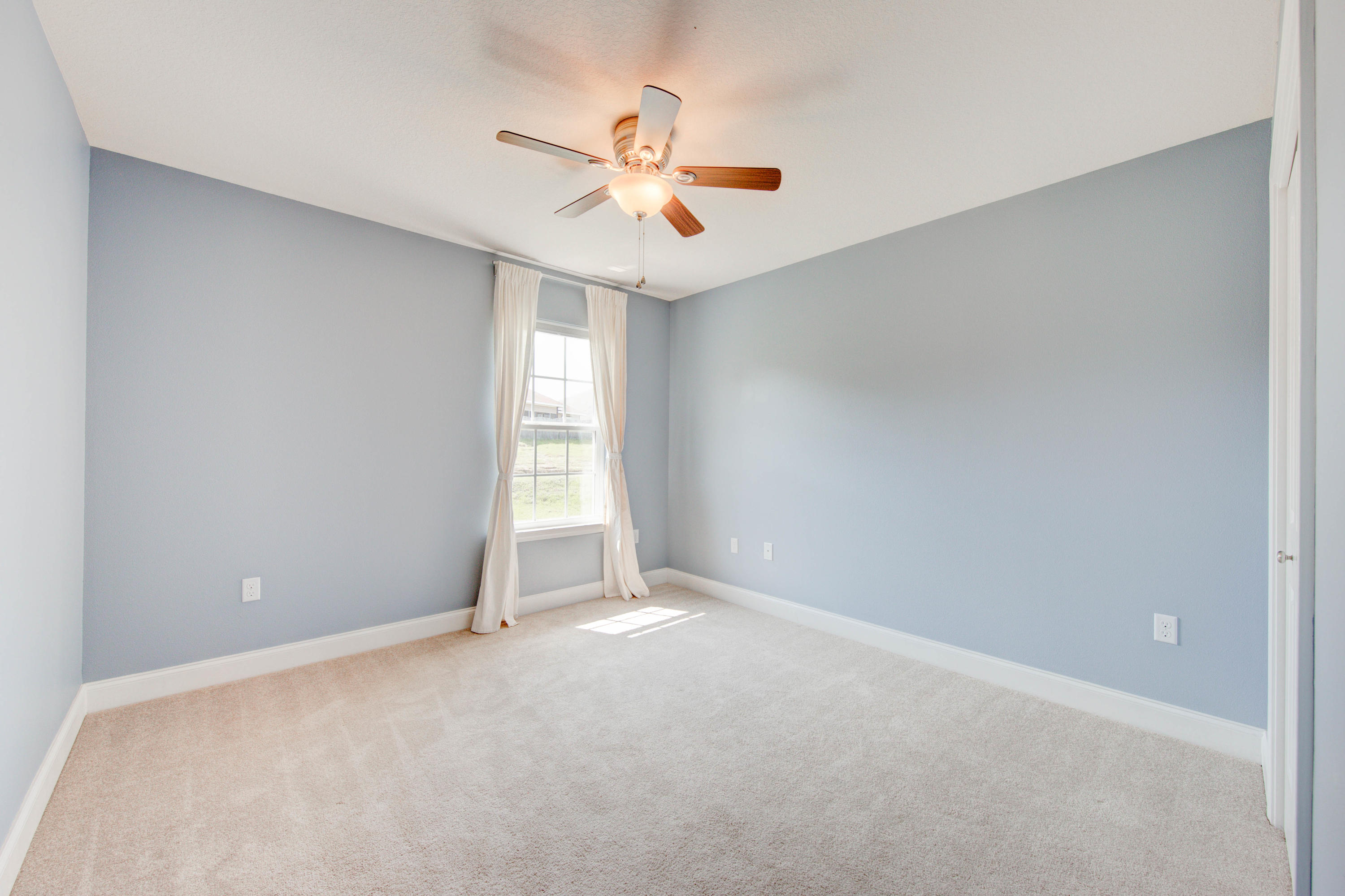 4557 Hermosa Road Crestview, FL 32539 - Photo 26 of 29 an empty room with windows and fan