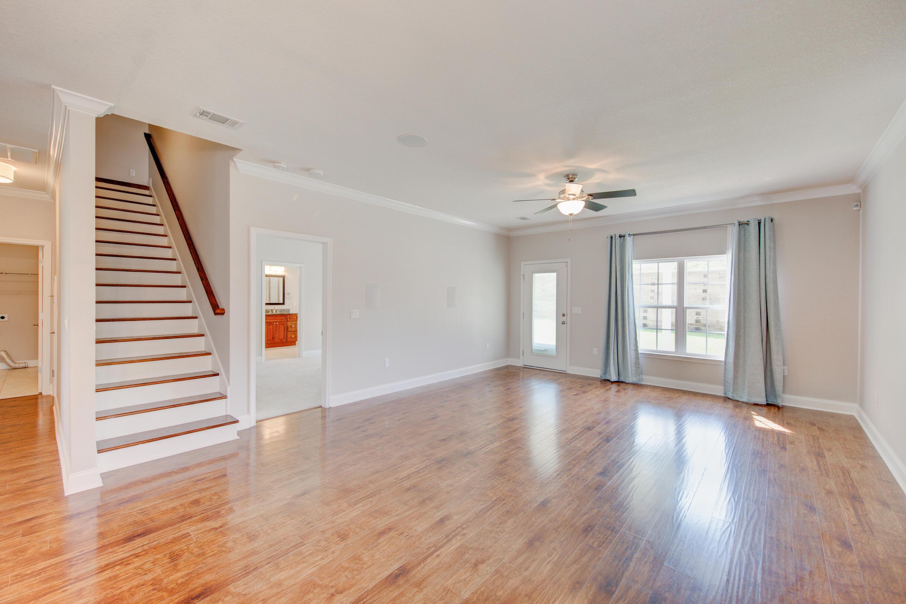 4557 Hermosa Road Crestview, FL 32539 - Photo 10 of 29 a view of an empty room with wooden floor and window