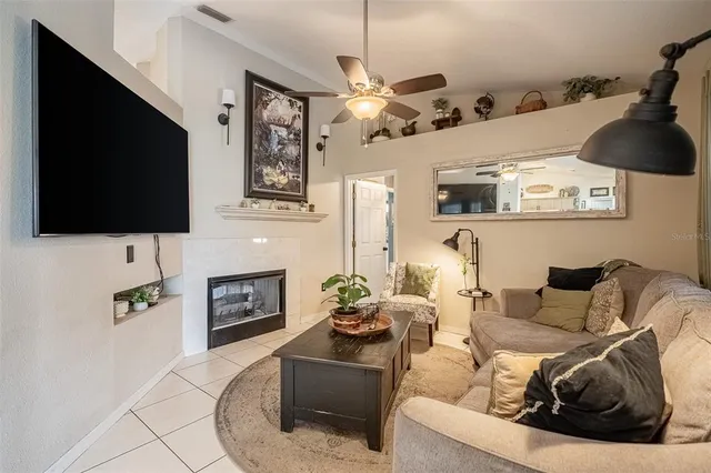 a kitchen with stainless steel appliances kitchen island granite countertop a table chairs and a refrigerator