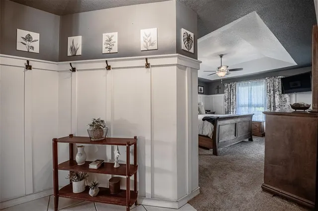 a kitchen with a table chairs microwave and cabinets