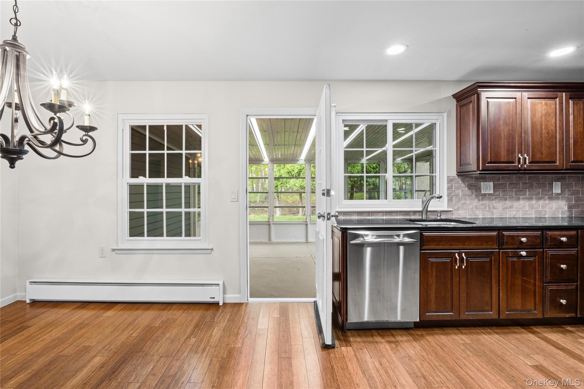 220 Belfast Lane Ridge, NY 11961 - Photo 28 of 44 a kitchen with a stove a sink and wooden floor