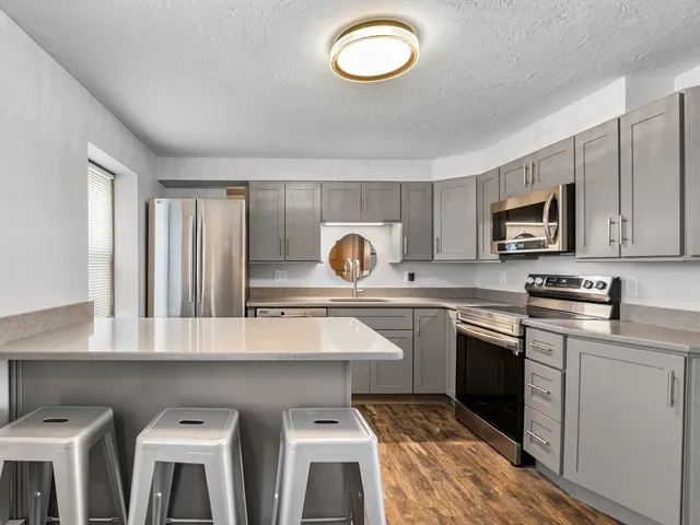 a kitchen with cabinets a sink and appliances