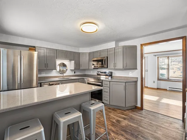 a kitchen with a sink cabinets and window