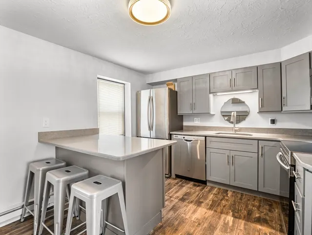 a kitchen with furniture a sink and appliances