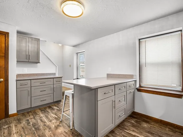 a spacious bathroom with a granite countertop sink and a mirror
