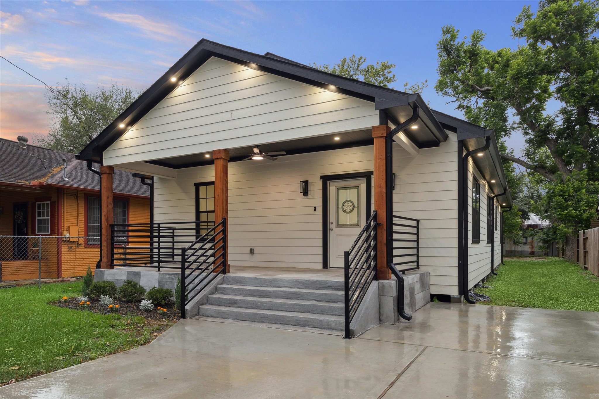 228 Lenox Street Houston, TX 77011 - Photo 1 of 16 a front view of a house with a garden