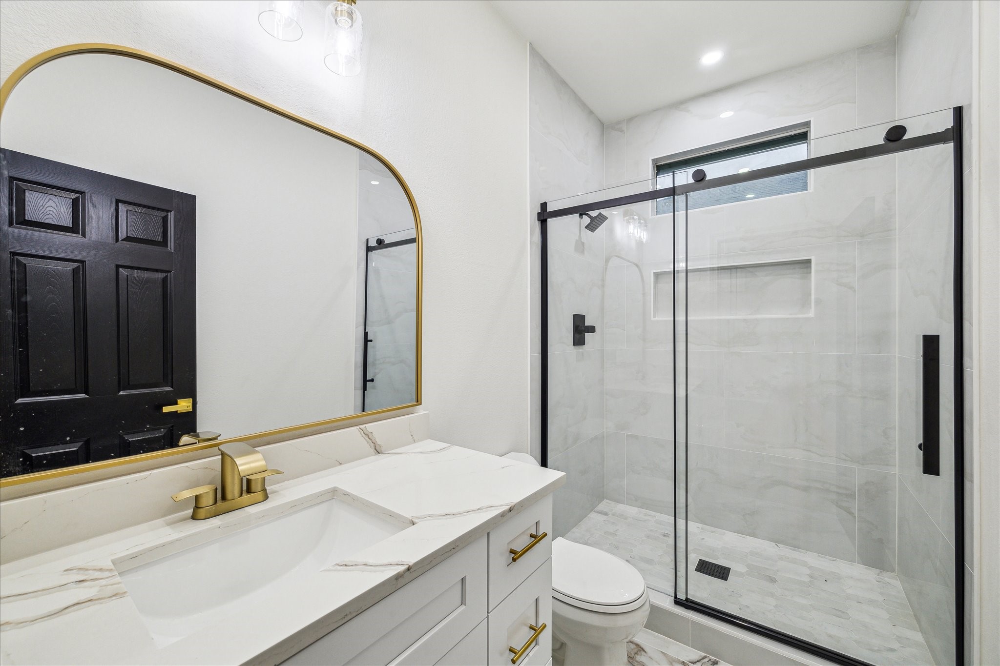 228 Lenox Street Houston, TX 77011 - Photo 12 of 16 a bathroom with a shower sink vanity mirror and toilet