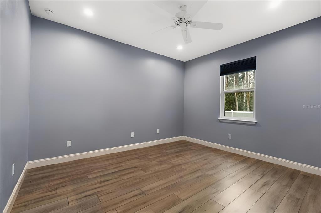 4 Uturn Court Palm Coast, FL 32164 - Photo 13 of 26 a view of an empty room with wooden floor and a window