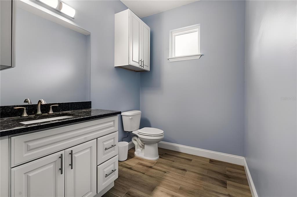 4 Uturn Court Palm Coast, FL 32164 - Photo 15 of 26 a bathroom with a sink a toilet and cabinets