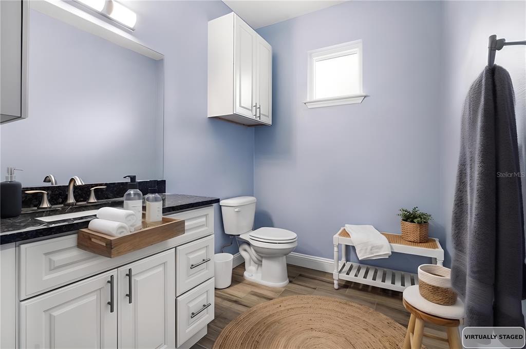 4 Uturn Court Palm Coast, FL 32164 - Photo 16 of 26 a bathroom with a toilet sink and mirror