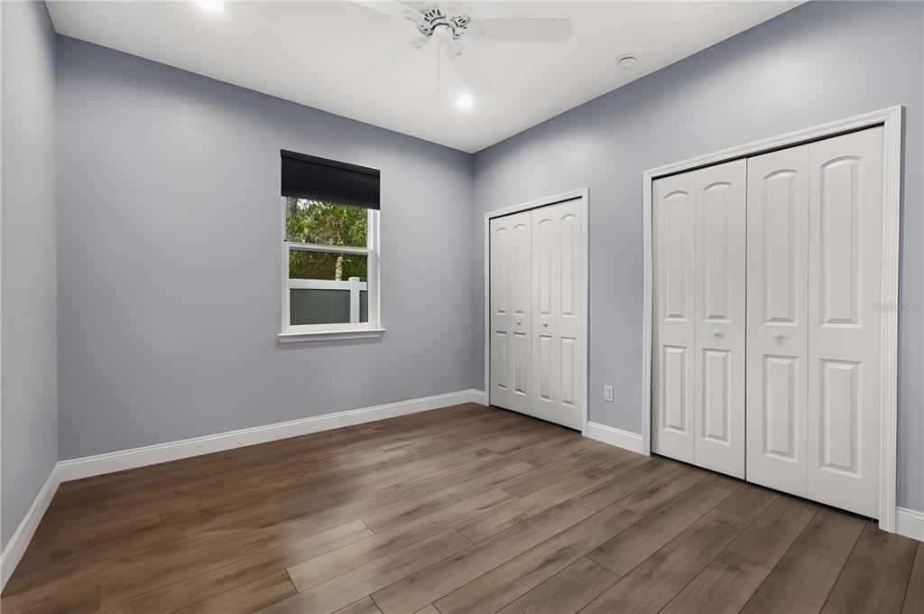 4 Uturn Court Palm Coast, FL 32164 - Photo 17 of 26 a view of an empty room with wooden floor and a window
