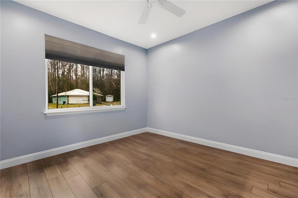 4 Uturn Court Palm Coast, FL 32164 - Photo 19 of 26 an empty room with wooden floor and windows