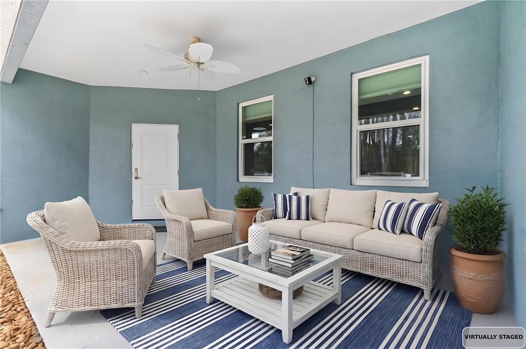 4 Uturn Court Palm Coast, FL 32164 - Photo 25 of 26 a living room with furniture potted plant and a window