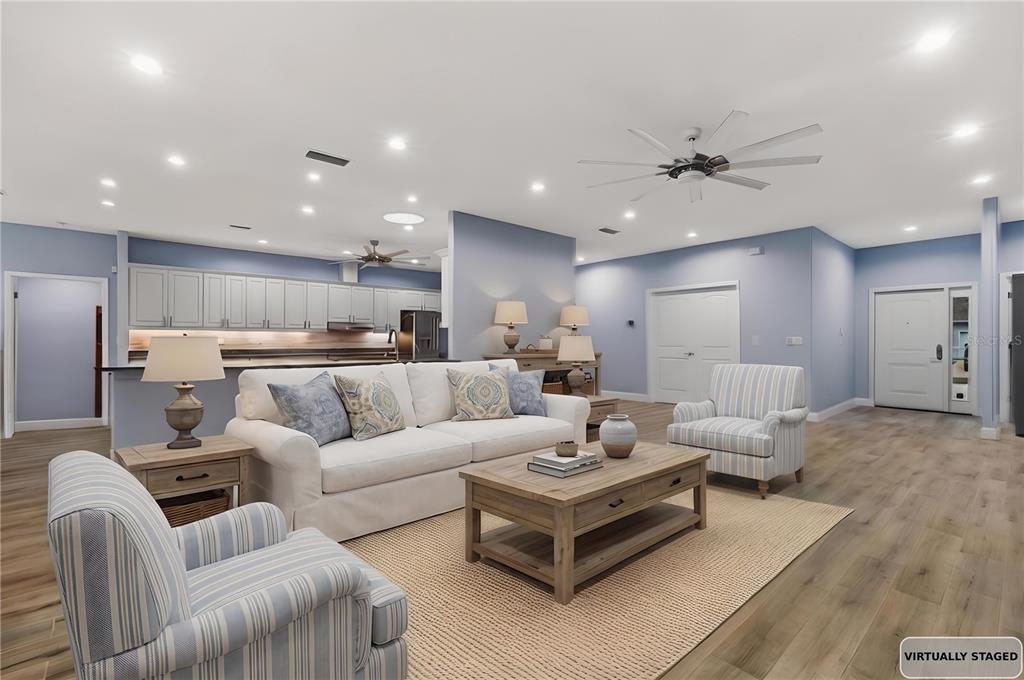4 Uturn Court Palm Coast, FL 32164 - Photo 3 of 26 a living room with furniture kitchen view and a chandelier