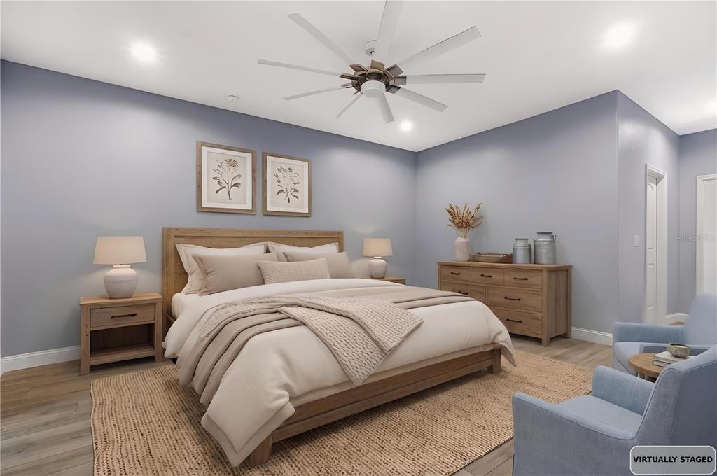 4 Uturn Court Palm Coast, FL 32164 - Photo 8 of 26 a bedroom with a bed and a chandelier