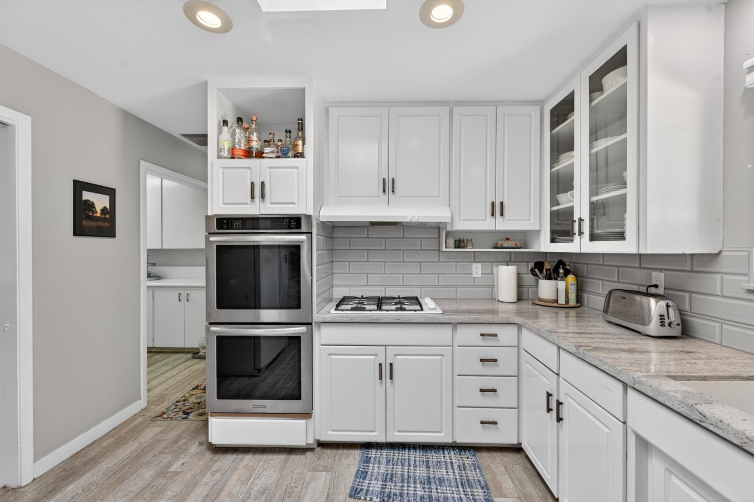 1880 Magnolia Street Gridley, CA 95948 - Photo 22 of 95 a kitchen with white cabinets and appliances