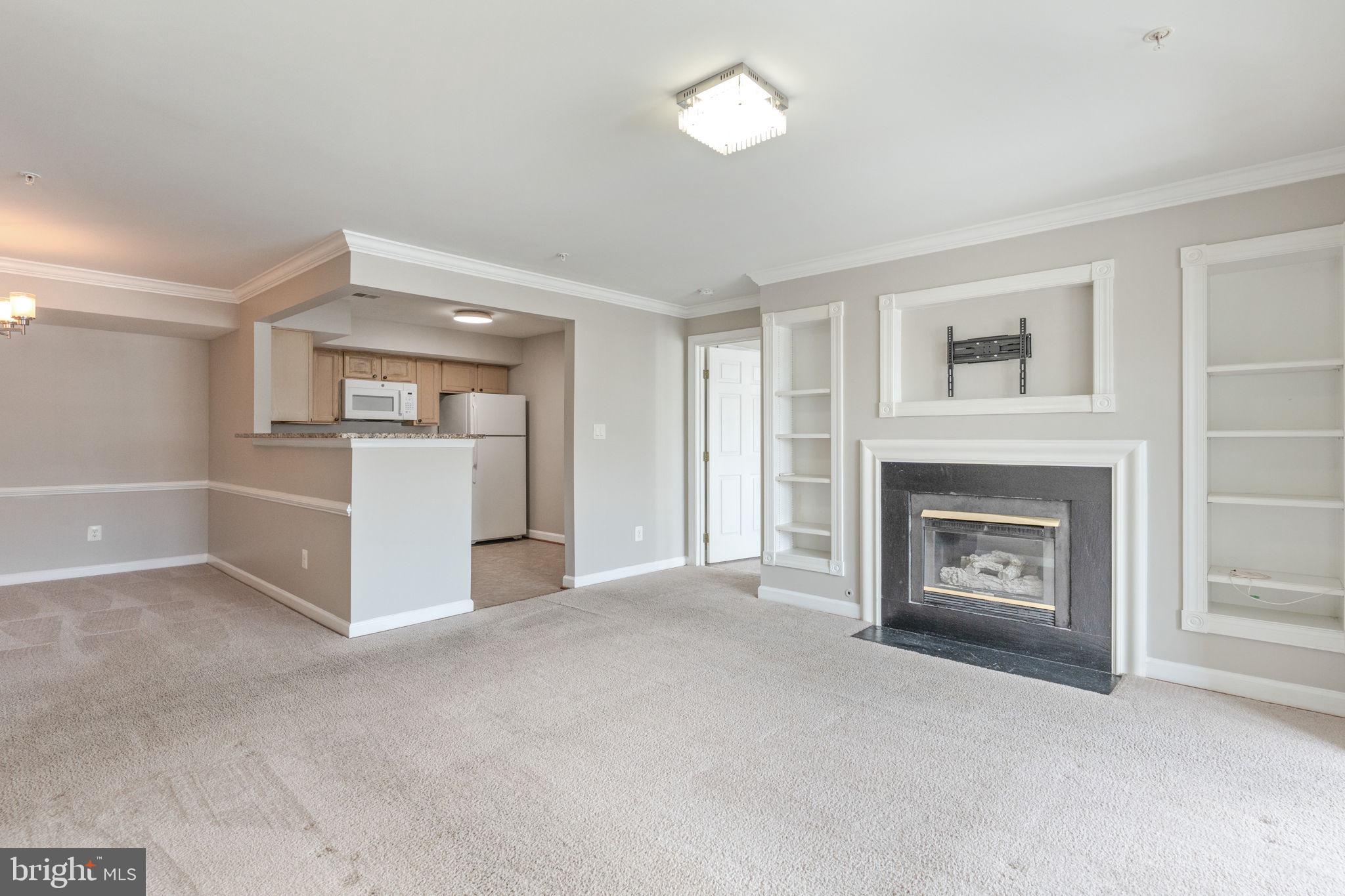 9224 Cardinal Forest Lane, Unit E Lorton, VA 22079 - Photo 1 of 33 a view of a livingroom with an empty space and a fireplace