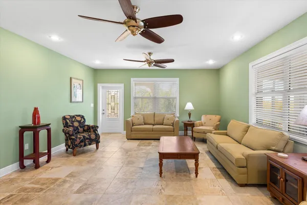 a living room with furniture and a floor to ceiling window