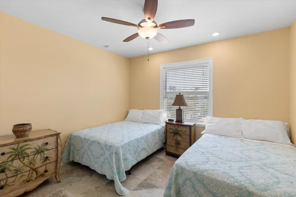 a bedroom with a bed and a painting on the wall