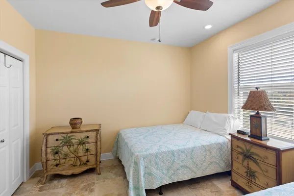 a bedroom with a bed and a painting on the wall