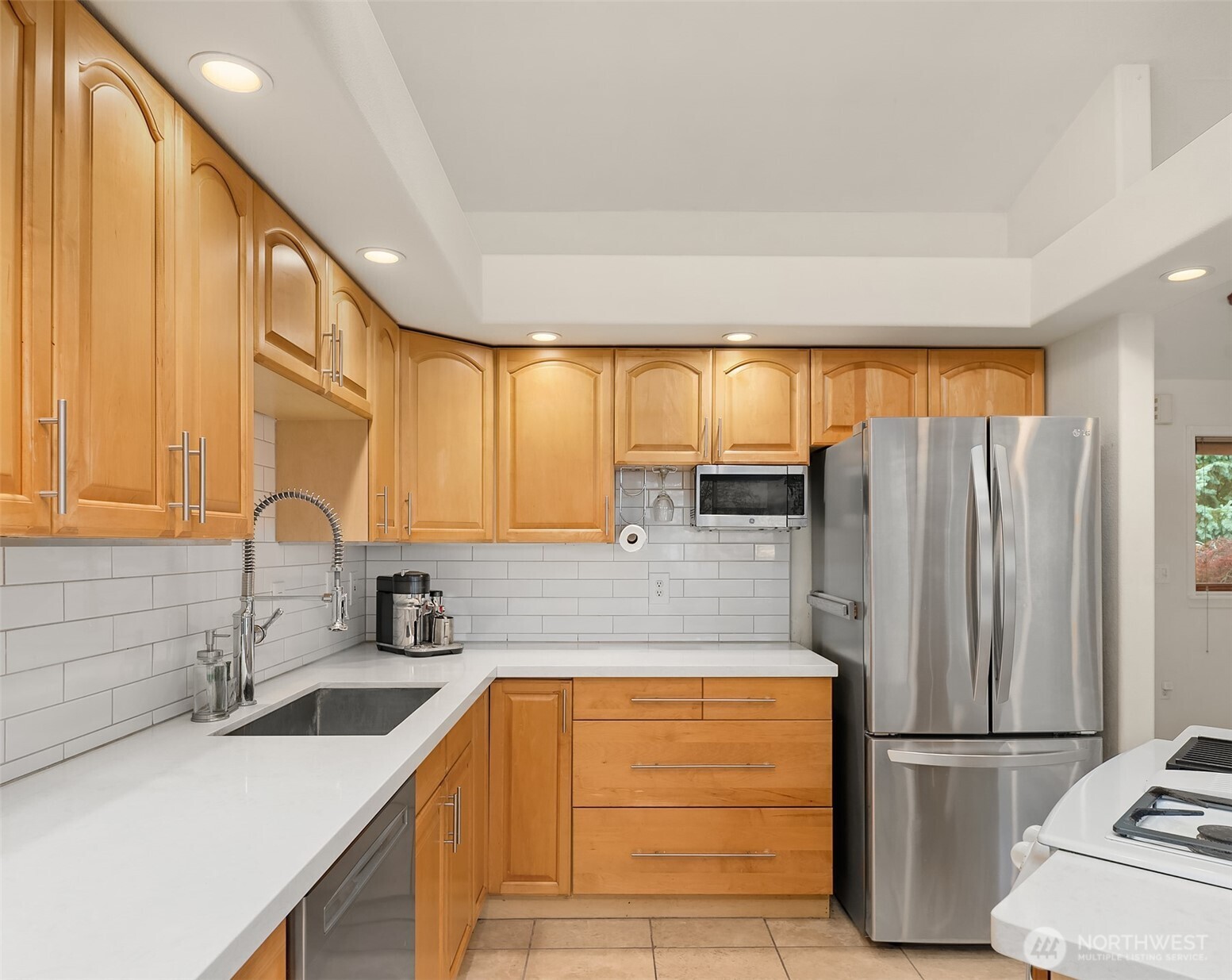 811 Southwest Langston Road Renton, WA 98057 - Photo 3 of 30 a kitchen with stainless steel appliances granite countertop a refrigerator and a sink