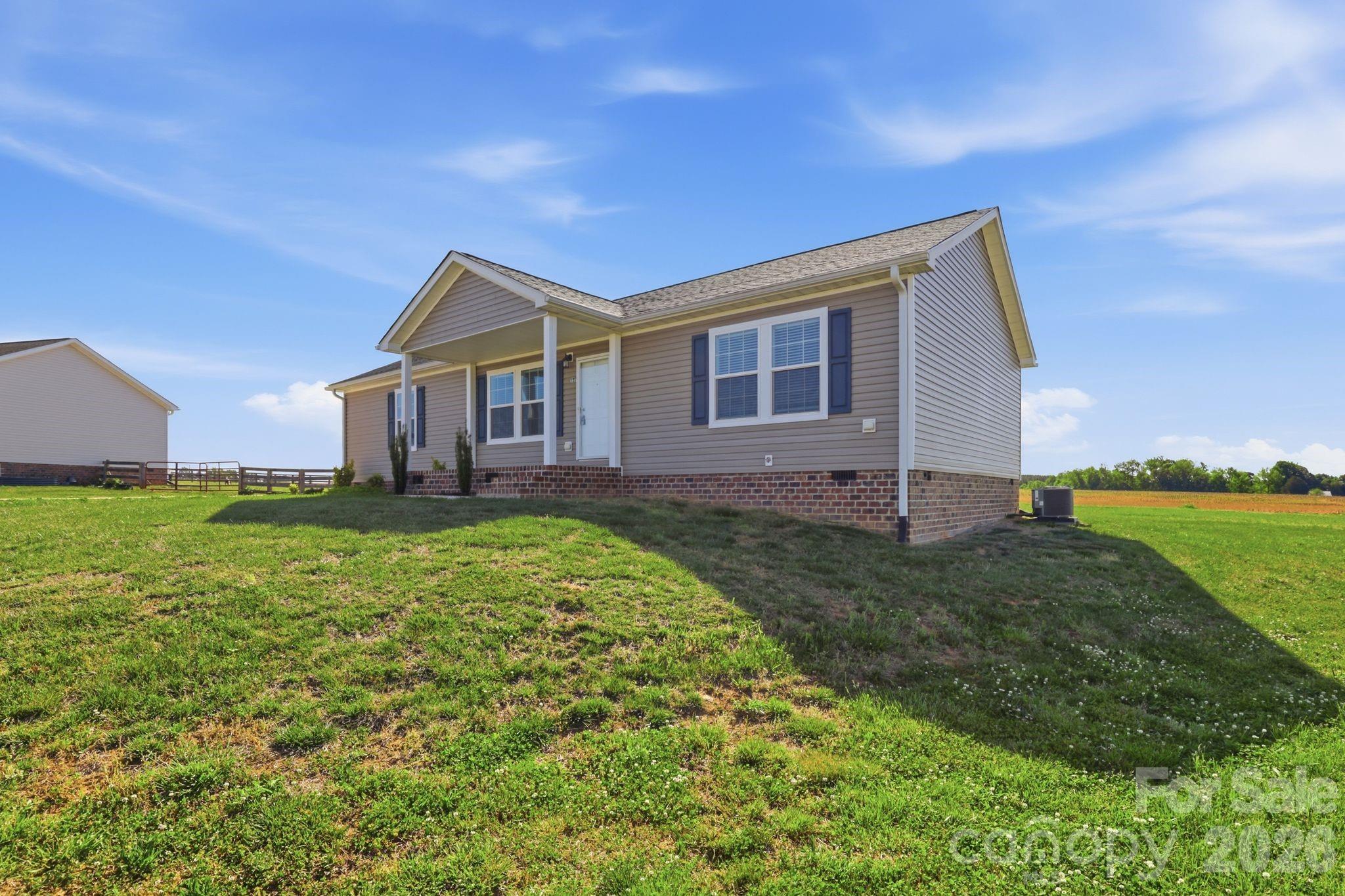 197 Burleson Point Woodleaf, NC 27054 - Photo 2 of 30 a front view of a house with garden