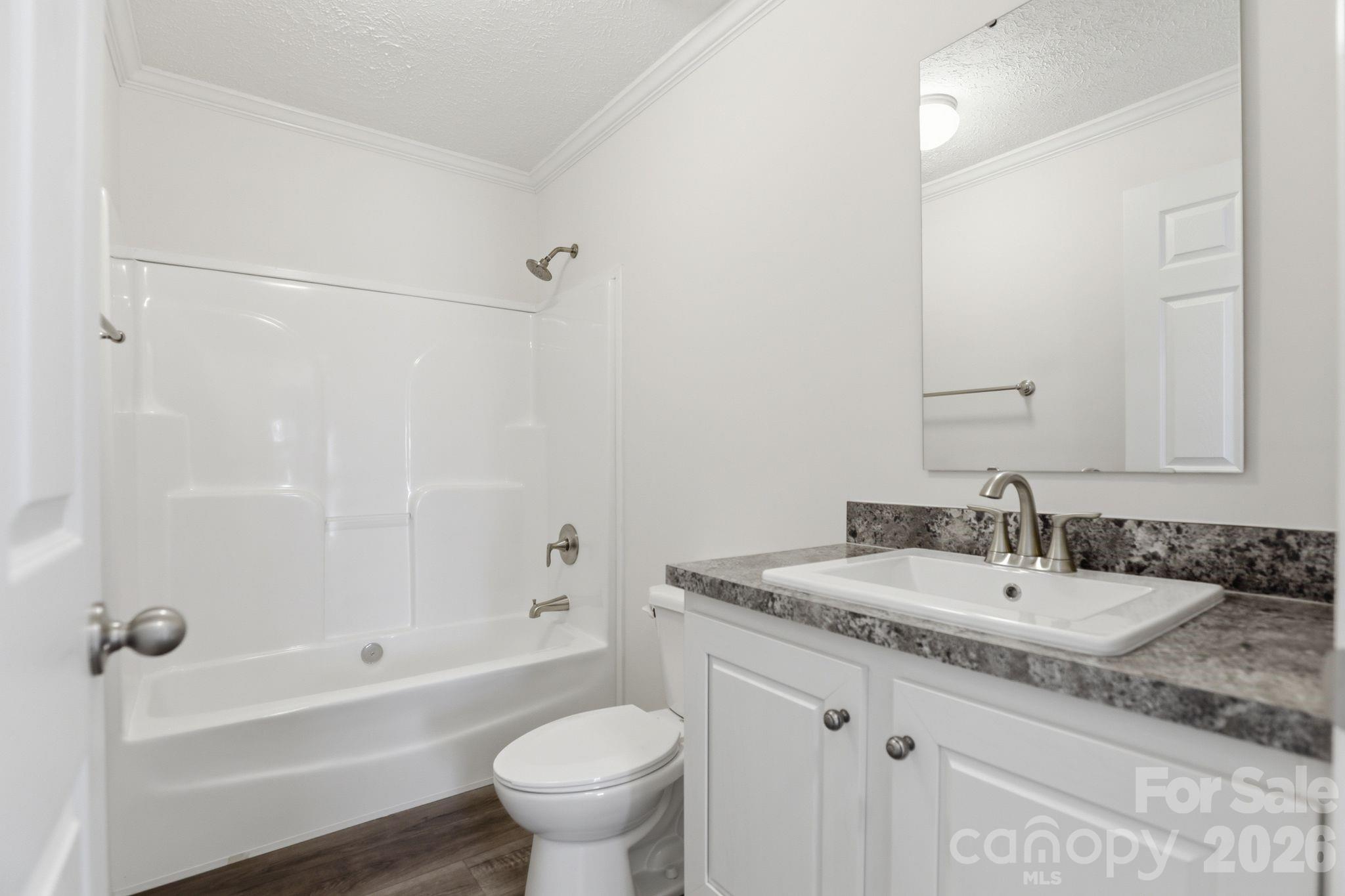 197 Burleson Point Woodleaf, NC 27054 - Photo 21 of 30 a bathroom with a granite countertop sink a toilet and shower