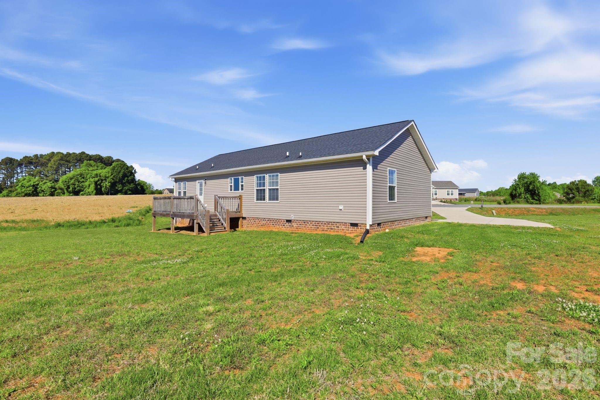 197 Burleson Point Woodleaf, NC 27054 - Photo 28 of 30 a view of an house with backyard space and garden