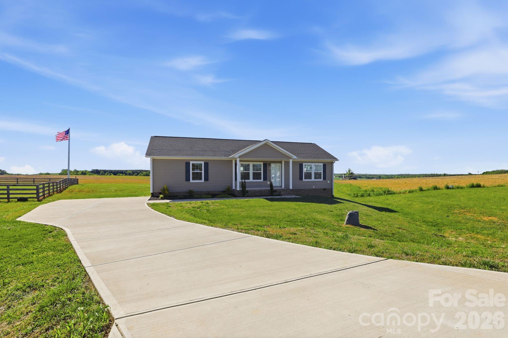 197 Burleson Point Woodleaf, NC 27054 - Photo 29 of 30 a front view of a house with a yard and garage